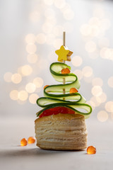 Christmas tree canape with cucumber slice, salmon pate and red caviar for festive xmas snack