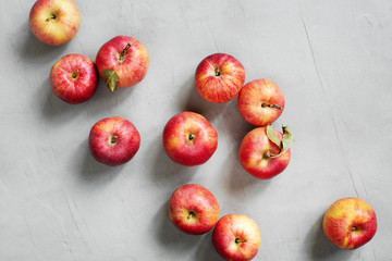 Red fresh juicy apples on the grey table