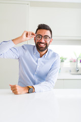 Fototapeta premium Handsome business man wearing glasses and smiling cheerful with confident smile on face