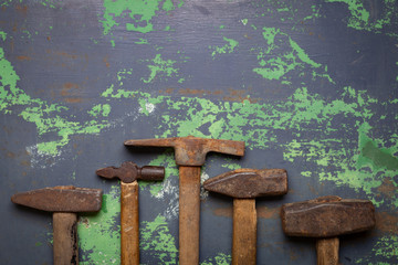 set of old hammers and rusty nails. tools on metal the surface.