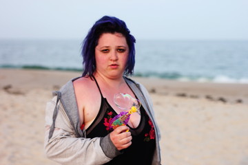 Fototapeta na wymiar Beautiful woman posing with a toy bubble gun on the beach 