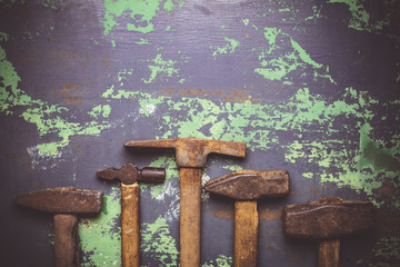 set of old hammers and rusty nails. tools on metal the surface.