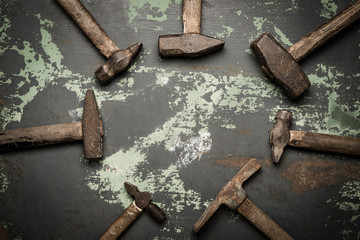 set of old hammers and rusty nails. tools on metal the surface.