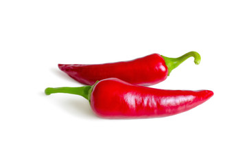 Pods of hot red chili peppers on white