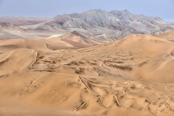 Fototapeta na wymiar Colorful sand dunes in the Namib-Naukluft National Park, Namibia