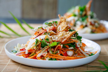 Thai salad with fresh vegetables, poached chicken and crispy chicken skin