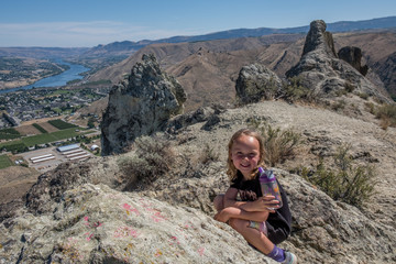 Smiling hiker girl at top of Saddle Rock hike in Wenatchee, Washington