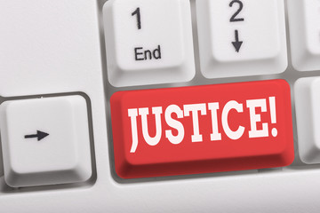 Writing note showing Justice. Business concept for impartial adjustment of conflicting claims or assignments White pc keyboard with note paper above the white background