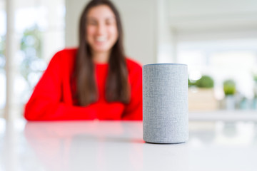 Young woman using home intelligent device, interactive voice assistant system