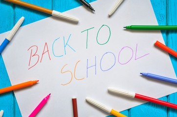 Creative idea depicting the return of children to school. School markers and a card with the text back to school.