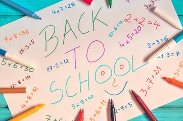 Creative idea depicting the return of children to school. School markers and a card with the text back to school.