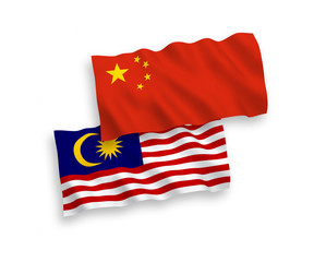National vector fabric wave flags of Malaysia and China isolated on white background 1 to 2 proportion.