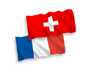 National vector fabric wave flags of France and Switzerland isolated on white background. 1 to 2 proportion.