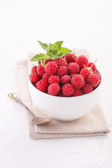 fresh raspberries with mint in a white Cup