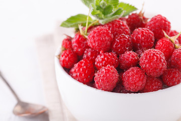 fresh raspberries with mint in a white Cup