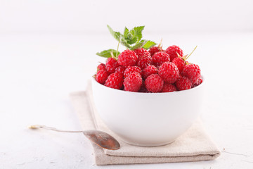 fresh raspberries with mint in a white Cup