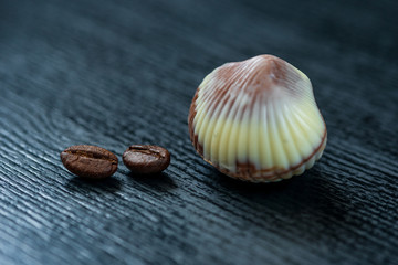 Belgian chocolates on a black wooden background. Photographed close-up.