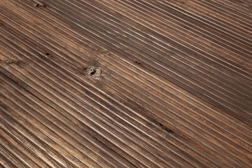 Obraz premium brown wooden floor with a swirl, parquet or laminate, ribbed surface