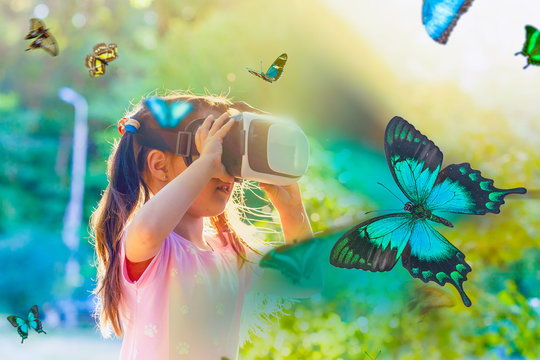 Excited siblings using virtual reality headset and looking at butterflies