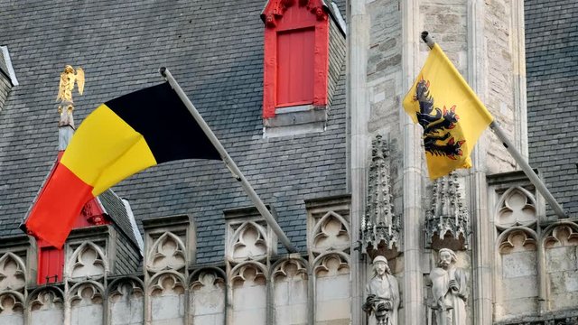 Flag of Flanders and Belgium flag on old building