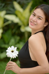 Smiling Beautiful Asian Female With Flowers