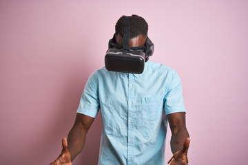 Young african american man playing virtual reality game using goggles