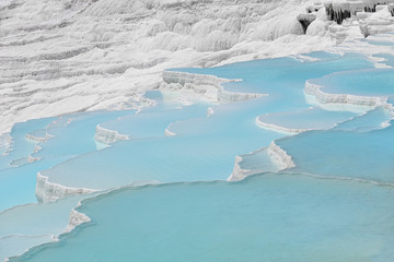 Beautiful natural travertine pools and terraces view from Pamukkale, Denizli, Turkey. Cotton castle at sunny bright day.