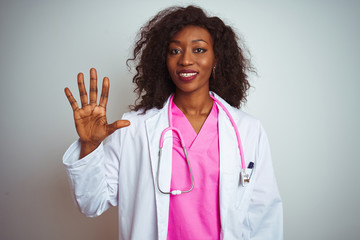 African american doctor woman wearing  pink stethoscope over isolated white background showing and pointing up with fingers number five while smiling confident and happy.