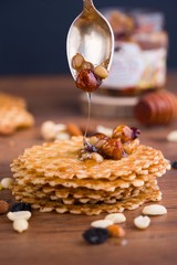 Tasty and healthy honey with nuts on the table.