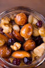 Tasty and healthy honey with nuts on the table.