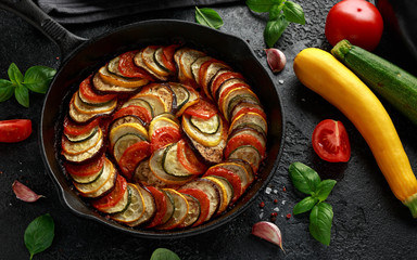 Ratatouille Vegetable Stew with zucchini, eggplants, tomatoes, garlic, onion and basil. on cast...