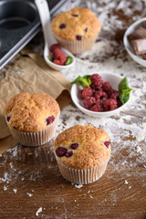 Delicious flavored cupcake with raspberries, white cream, and chocolate icing.