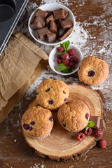 Delicious flavored cupcake with raspberries, white cream, and chocolate icing.