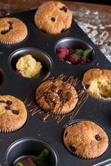 Delicious flavored cupcake with raspberries, white cream, and chocolate icing.