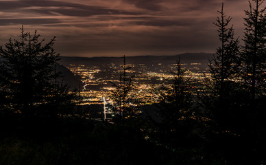 Evening top view of the city lights,French Annemasse, Swiss Geneva,dark sky background, photo with long exposure.Department of Haute-Savoie in France. 