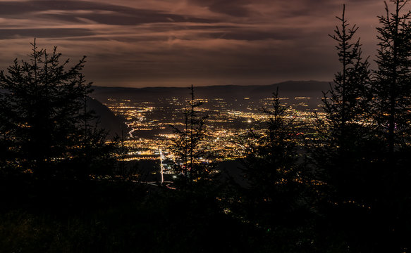 Evening top view of the city lights,French Annemasse, Swiss Geneva,dark sky background, photo with long exposure.Department of Haute-Savoie in France. 