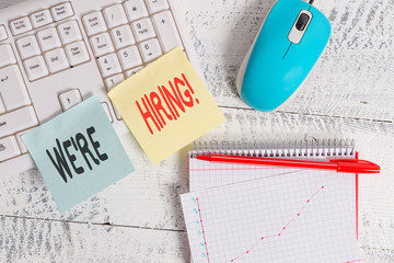 Handwriting text writing We Re Hiring. Conceptual photo recently employ someone or pay someone to do particular job Writing equipments and computer stuffs placed above classic wooden table
