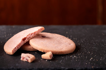 Sweet raspberry biscuits on a dark slate