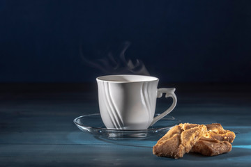 Morning cup of coffee lit by the first rays of the sun.