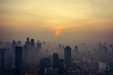 Fototapeta na wymiar Foggy skyscrapers and residential at dawning