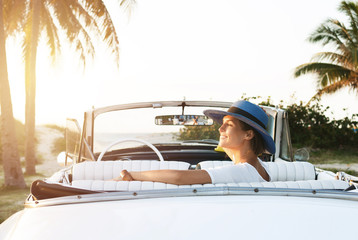 Happy young woman and retro convertible car