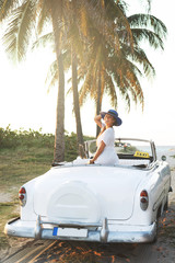 Happy young woman and retro convertible car