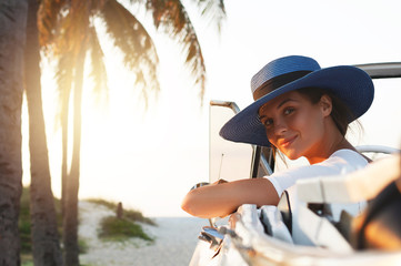 Happy young woman and retro convertible car