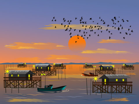 Fishing village on the sea with mountain and sunset background,fishing boat on sea,Flock of birds in the sky