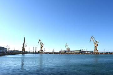 Fototapeta na wymiar Cranes to repair boats on the coast of the capital city of Cadiz. Andalusia. Spain. Europe.