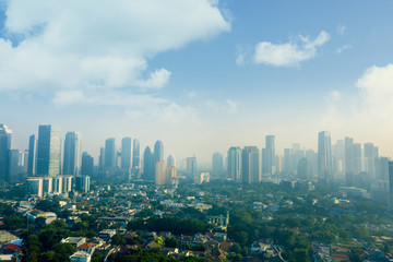Jakarta city with dense residential at misty morning