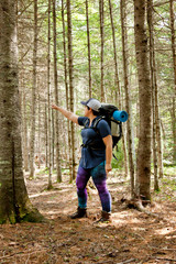 Woman points while hiking