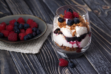 Curd dessert with raspberries, blueberries and cookies