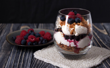 Curd dessert with raspberries, blueberries and cookies