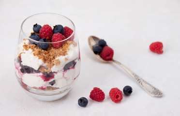 Curd dessert with raspberries, blueberries and cookies